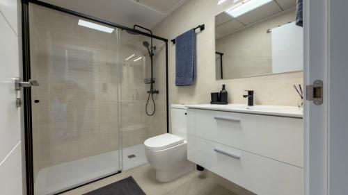 Modern guest bathroom with vanity and spacious walk-in shower